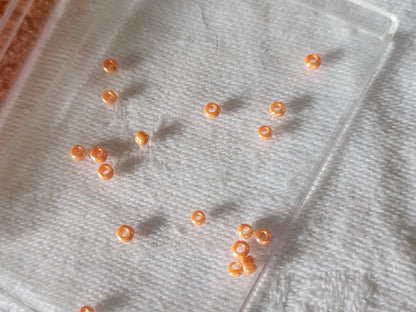 Lot environ 18  grammes de perles rocaille orange satiné n°13
